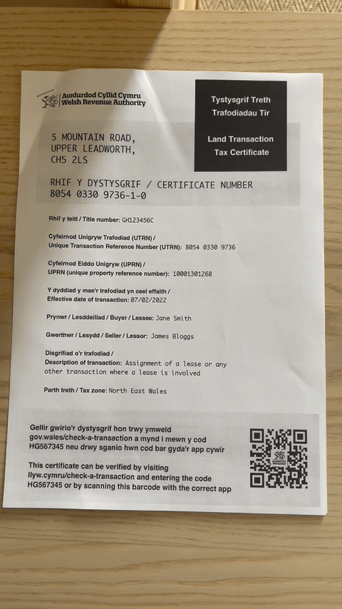 ALT: A paper mockup of a Land Transaction Tax certificate in English and Welsh. It includes a signed QR code and a one-time code that can be used as part of a ‘tell us once’ service for moving home.
